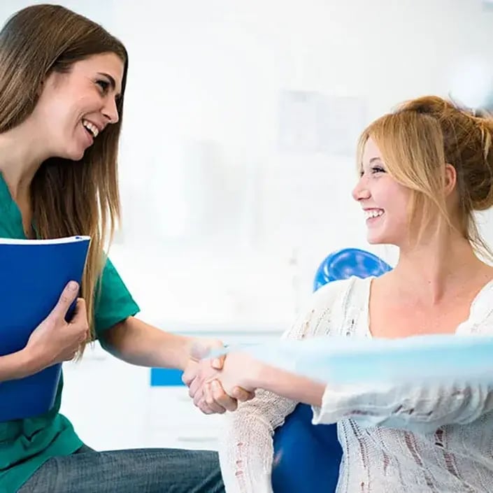 female-patient-meeting-dentist-705x705